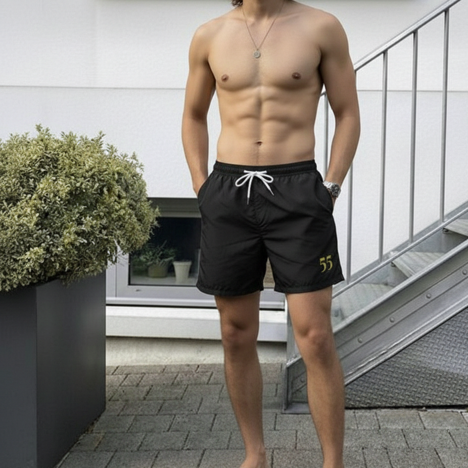 Minimal black swim shorts inspired by Brazil’s code 55, designed for summer comfort and relaxed coastal living.